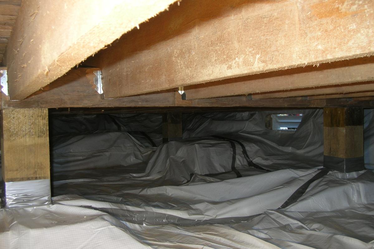 Another view of the vapor barrier as it extends towards the southeast corner of the crawlspace.