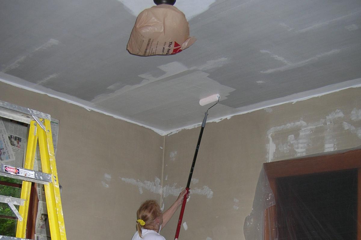 Painting the plaster ceiling in the stage area.